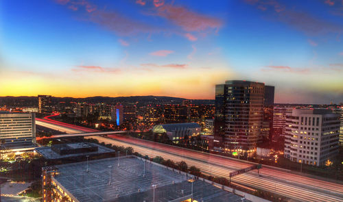 High angle view of illuminated cityscape against sky at night