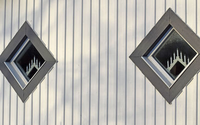 Low angle view of road sign against building