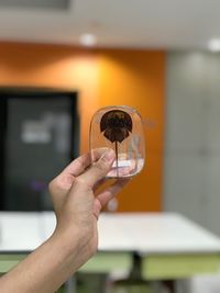 Midsection of woman holding glass