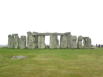 Old ruins on field against clear sky