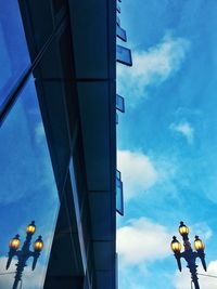 Low angle view of amusement park ride against blue sky