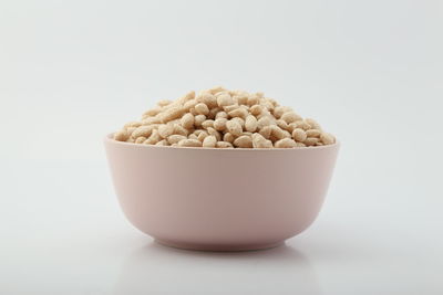 Close-up of ice cream in bowl against white background