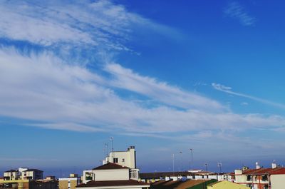 Buildings against cloudy blue sky