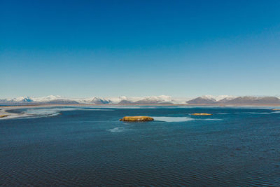 Scenic view of sea against clear blue sky