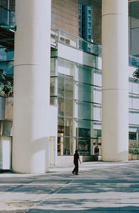 Man walking on street against buildings in city