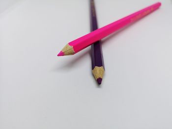 High angle view of colored pencils on white background