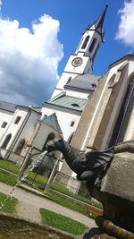 Low angle view of church against cloudy sky