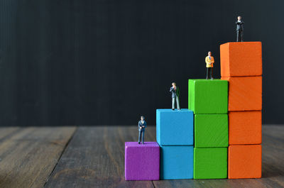 Close-up of figurines on toy blocks