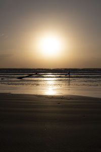 Scenic view of beach against sky during sunset