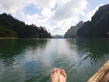 Low section of man relaxing in lake