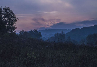 Scenic view of landscape against cloudy sky