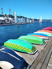 Multi colored pier over sea against blue sky