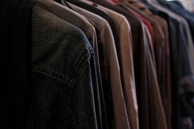 Close-up of clothes hanging in row