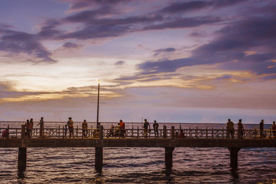 Pier on sea at sunset