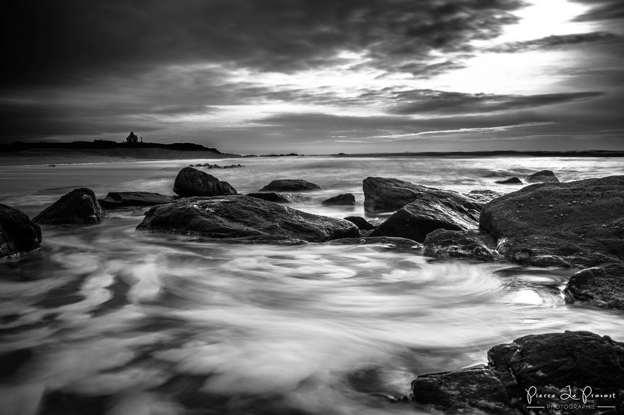 SCENIC VIEW OF SEA WITH ROCKS IN BACKGROUND