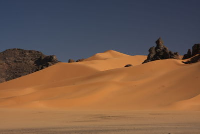 Scenic view of desert against clear sky acacus mountain, libya