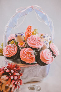 Bouquet of cupcake and marshmallows in basket. a gift on valentines day, birthday and anniversary.