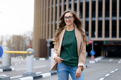 Portrait of woman wearing eyeglasses standing outdoors