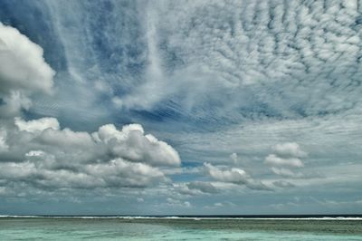 Scenic view of sea against cloudy sky