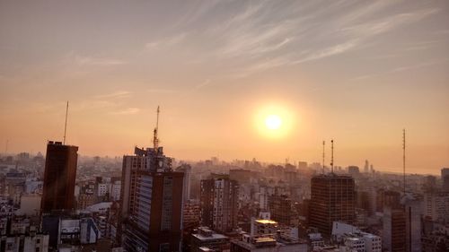 Cityscape against sky during sunset