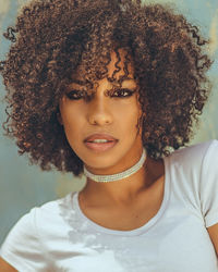 Close-up portrait of young woman with curly hair