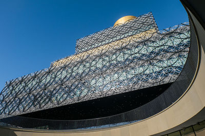 Low angle view of built structure against clear blue sky