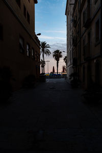 Footpath amidst buildings in city