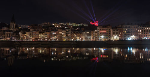 Panorama of the quai de saône in lyon at night with the illuminated fourvière basilica behind