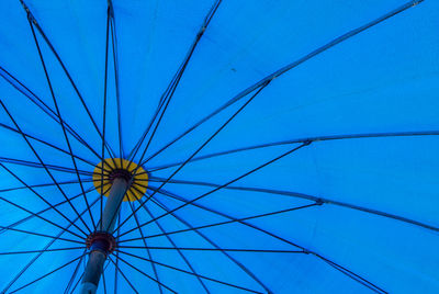 Low angle view of ferris wheel against blue sky