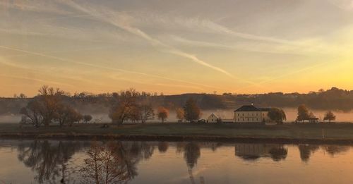 Scenic view of lake against sky during sunset
