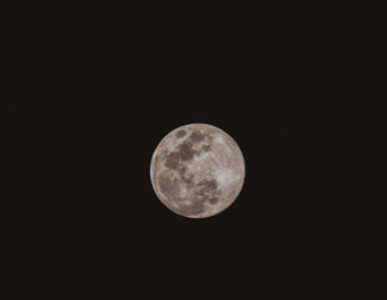 Low angle view of full moon against sky at night