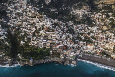 High angle view of townscape by sea