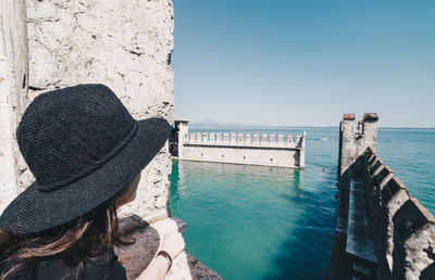 Side view of woman looking at castle against clear sky