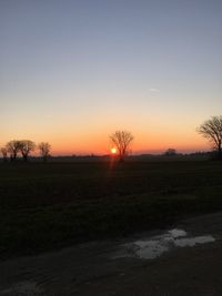 Scenic view of field against sky during sunset