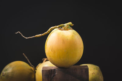 Close-up of apple on table against black background