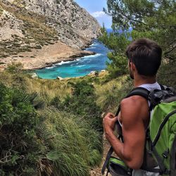 Man looking at sea and mountain