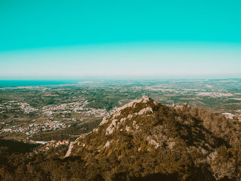 High angle view of land against clear blue sky