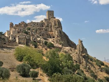 Castle on mountain against sky