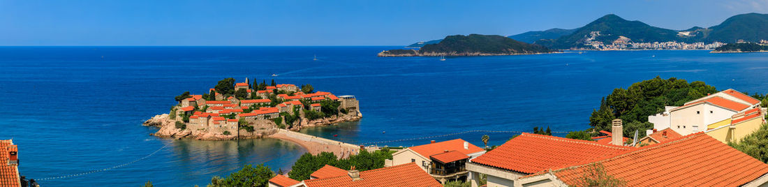 High angle view of townscape by sea against sky