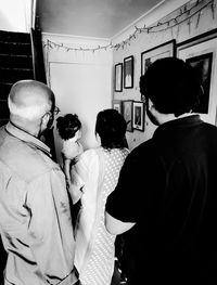 Rear view of man and woman standing in kitchen