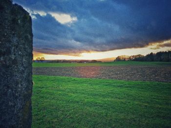 Scenic view of field against sky during sunset