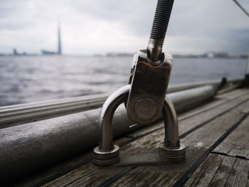 Close-up of rope on railing against sky