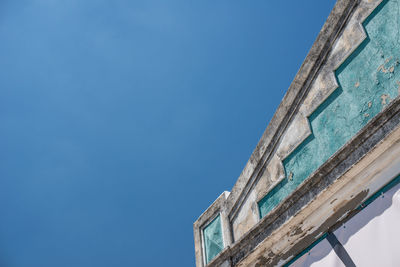 Low angle view of old building against clear blue sky