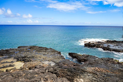 Scenic view of sea against cloudy sky