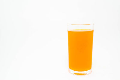 Close-up of beer glass against white background