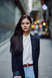 Portrait of young woman standing outdoors