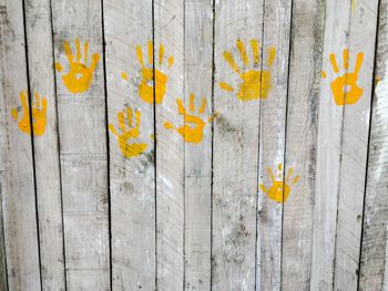 Handprints on wooden wall