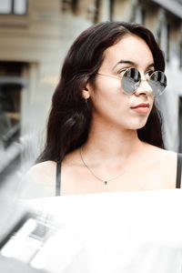 Portrait of young woman wearing sunglasses