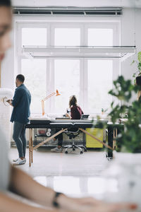 Rear view of people sitting on table