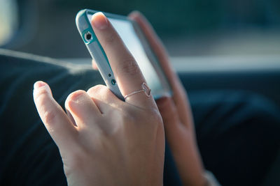Close-up of human hand holding mobile phone